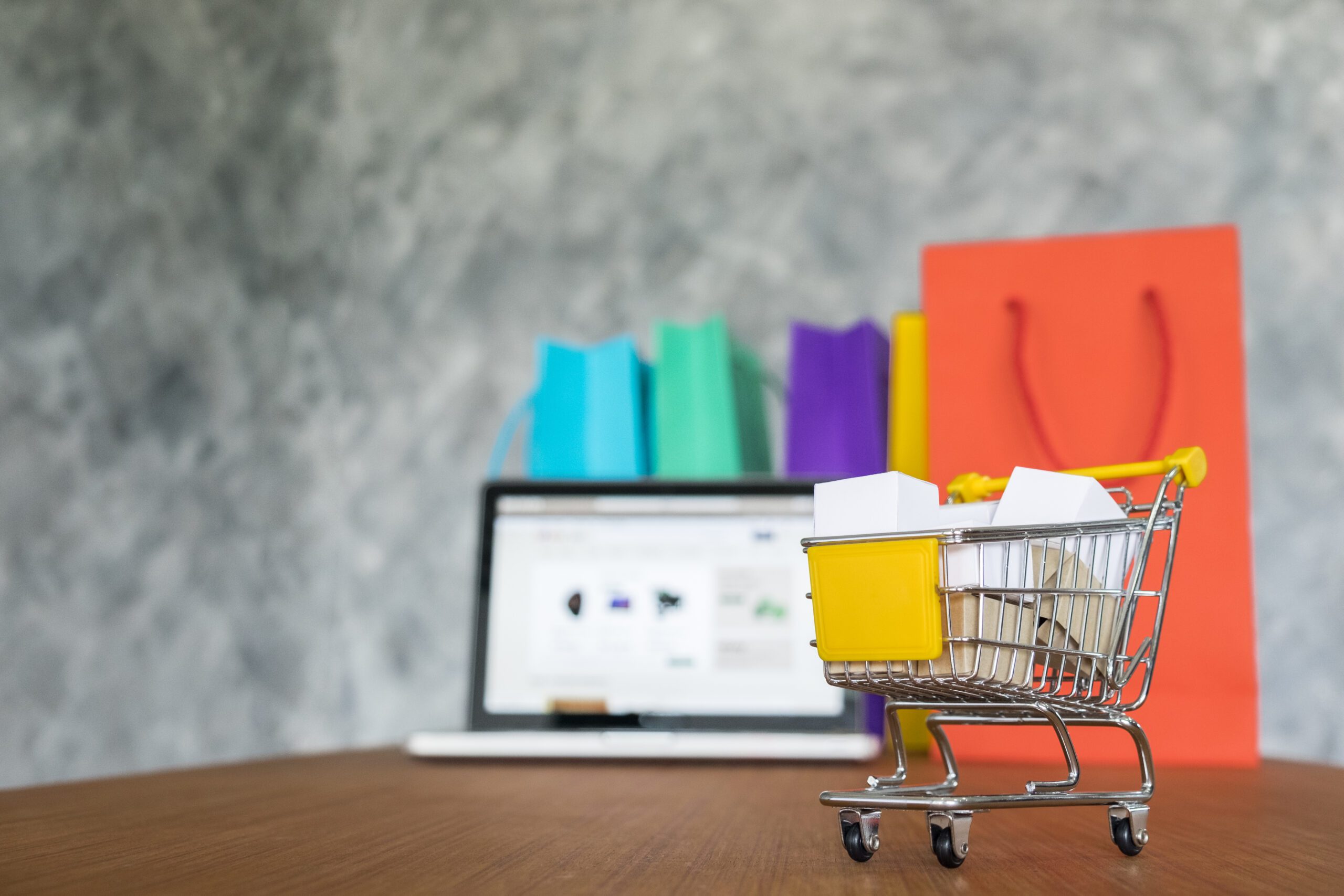 laptop shopping bags online shopping concept scaled
